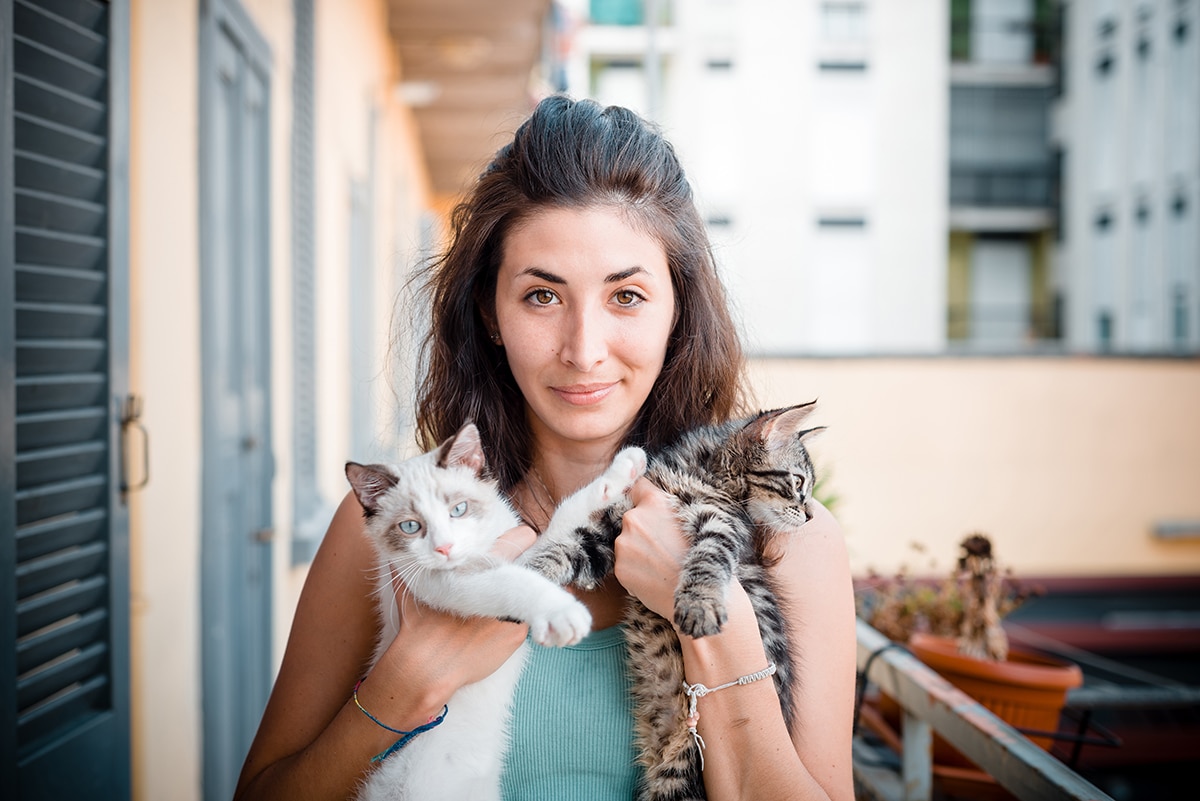 Woman with cats at her home