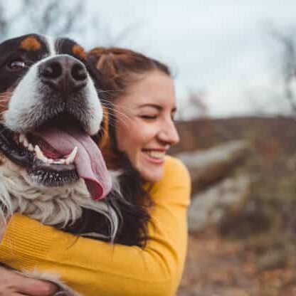 Young Woman Hugging Dog